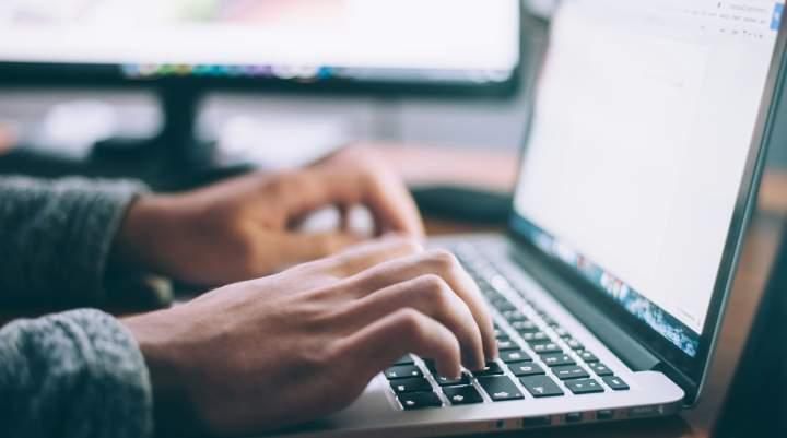 Hands on a laptop keyboard 